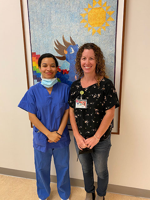 Jennie Link and Kate Ropp standing in front of a painting