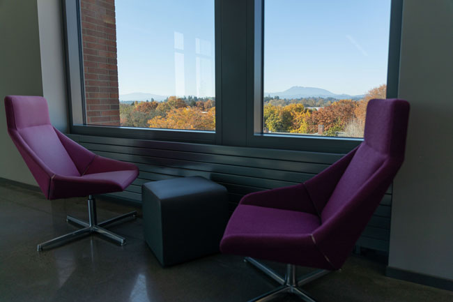 two red armchairs and a table next to windows that look out to Marys Peak