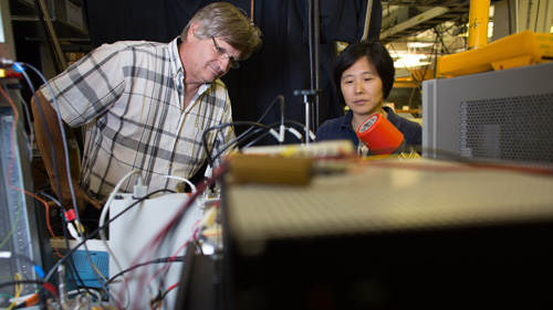 two people collaborating on a computer